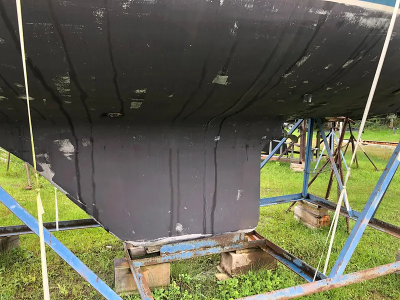 Slide: The Image of 1976 Tartan 30 sailboat hull on stands, showing keel and support structure. - 4