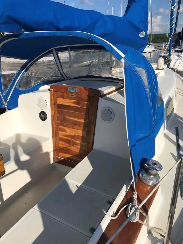 Slide: The Image of 1976 Tartan 30 sailboat cockpit with blue canopy and wooden hatch. - 40