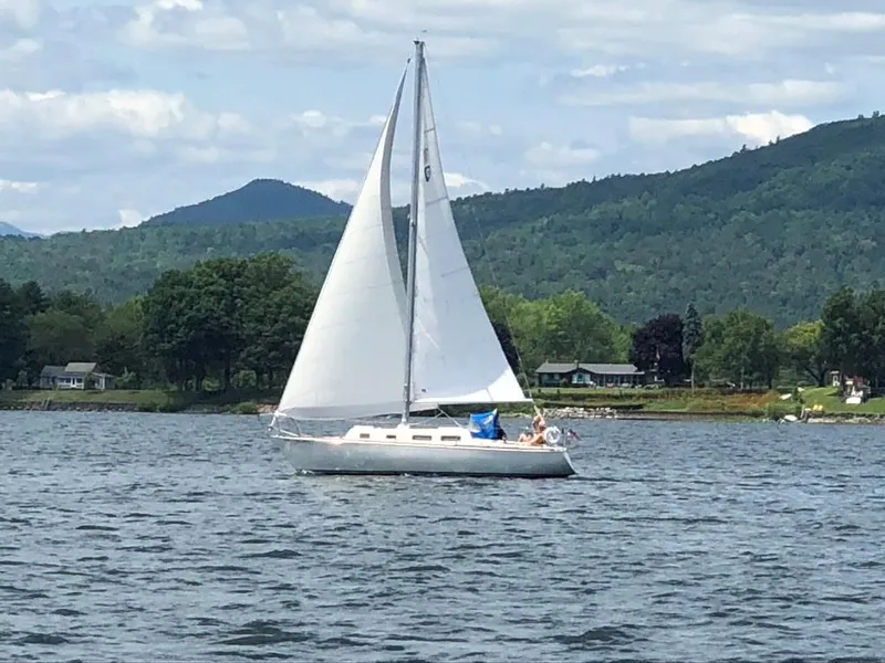 Slide: The Image of Sailboat Tartan 30 (1976) on a scenic lake with mountains in the background. - 41