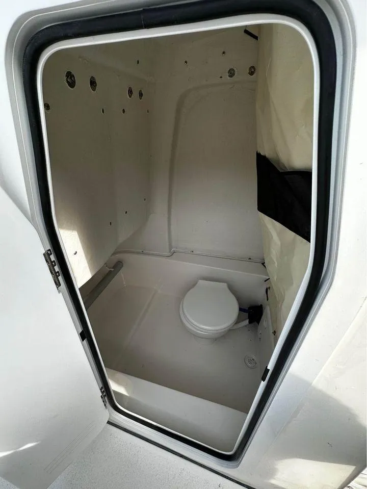 Slide: The Image of 2024 Sea Fox 248 Commander boat interior cabin with compact toilet. - 8