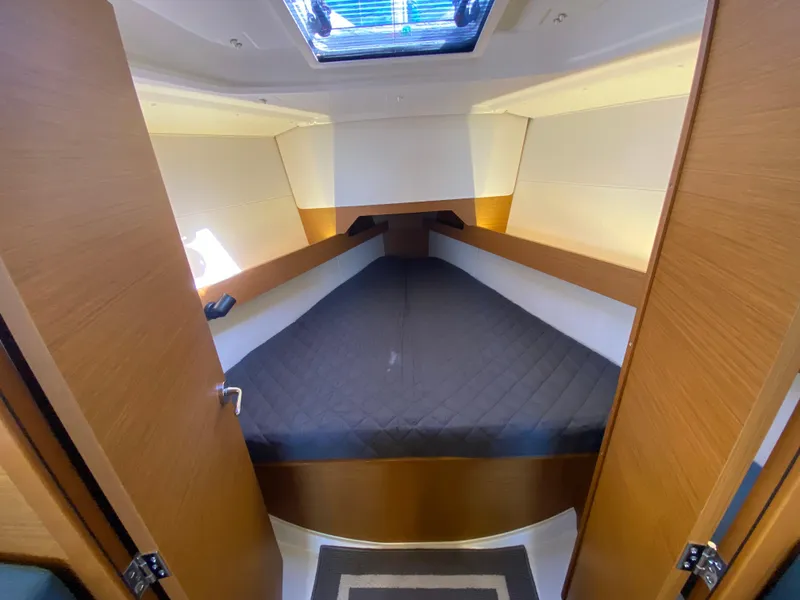 Slide: The Image of 2023 Jeanneau Sun Odyssey 349 cabin interior with cozy bed and skylight. - 15