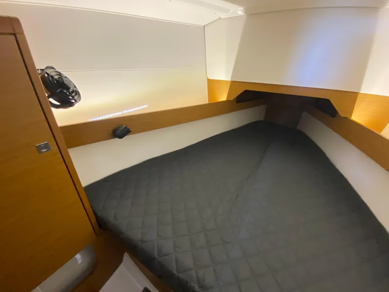 Slide: The Image of 2023 Jeanneau Sun Odyssey 349 cabin with cozy bed and modern wood finish. - 16