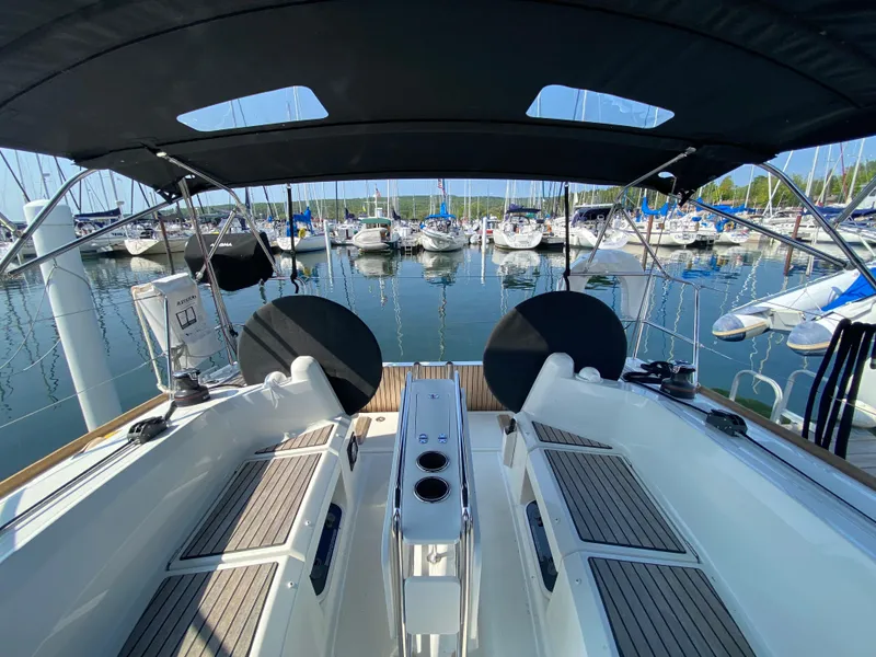 Slide: The Image of 2023 Jeanneau Sun Odyssey 349 sailboat cockpit with marina view. - 2