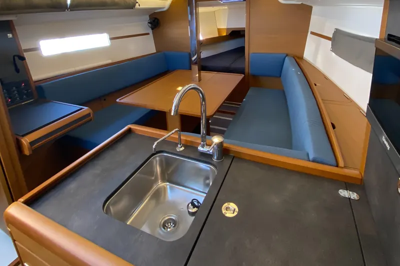 Slide: The Image of Interior of 2023 Jeanneau Sun Odyssey 349 sailboat with modern kitchen and seating area. - 20