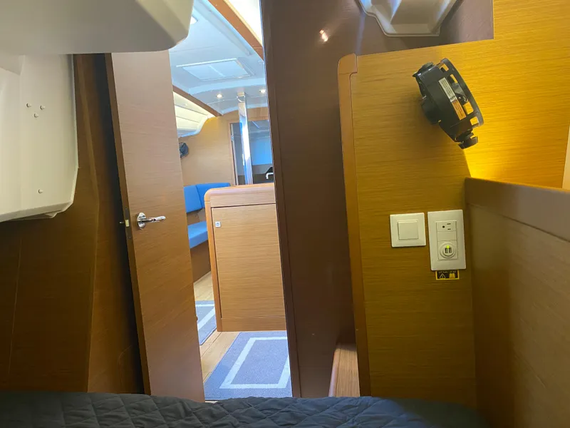Slide: The Image of Interior of 2023 Jeanneau Sun Odyssey 349 sailboat, featuring wood paneling and modern fixtures. - 21