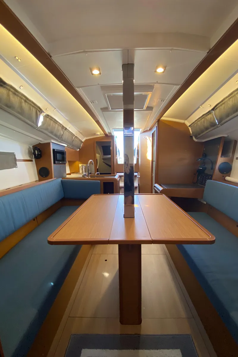 Slide: The Image of Interior of 2023 Jeanneau Sun Odyssey 349 sailboat with modern seating and dining area. - 23