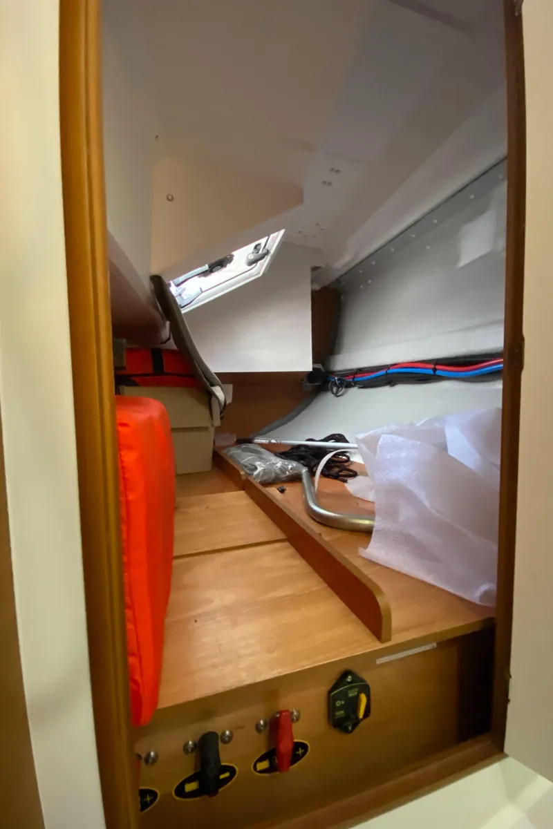 Slide: The Image of 2023 Jeanneau Sun Odyssey 349 interior storage compartment with equipment and safety gear. - 29
