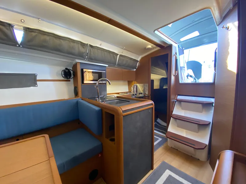 Slide: The Image of 2023 Jeanneau Sun Odyssey 349 interior with modern kitchen and seating area. - 8