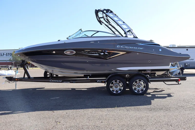 Slide: The Image of 2024 Crownline Eclipse E255 SURF boat displayed indoors, featuring sleek design and modern seating. - 1