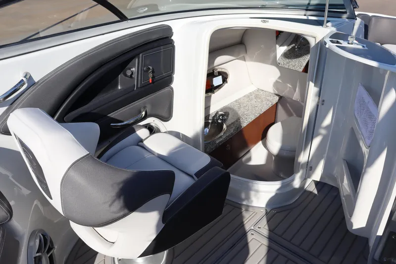 Slide: The Image of 2024 Crownline Eclipse E255 SURF boat interior with modern seating and ambient lighting. - 12