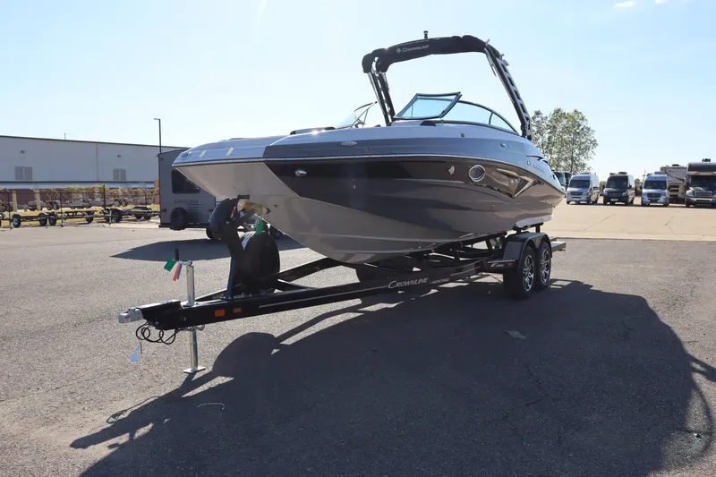 Slide: The Image of 2024 Crownline E255 Surf boat on trailer, side view. - 2