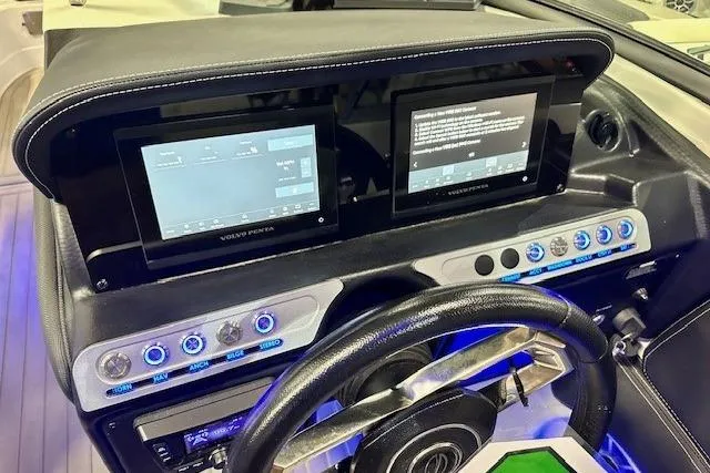 Slide: The Image of 2024 Crownline Eclipse E255 SURF dashboard with dual screens and illuminated controls. - 21