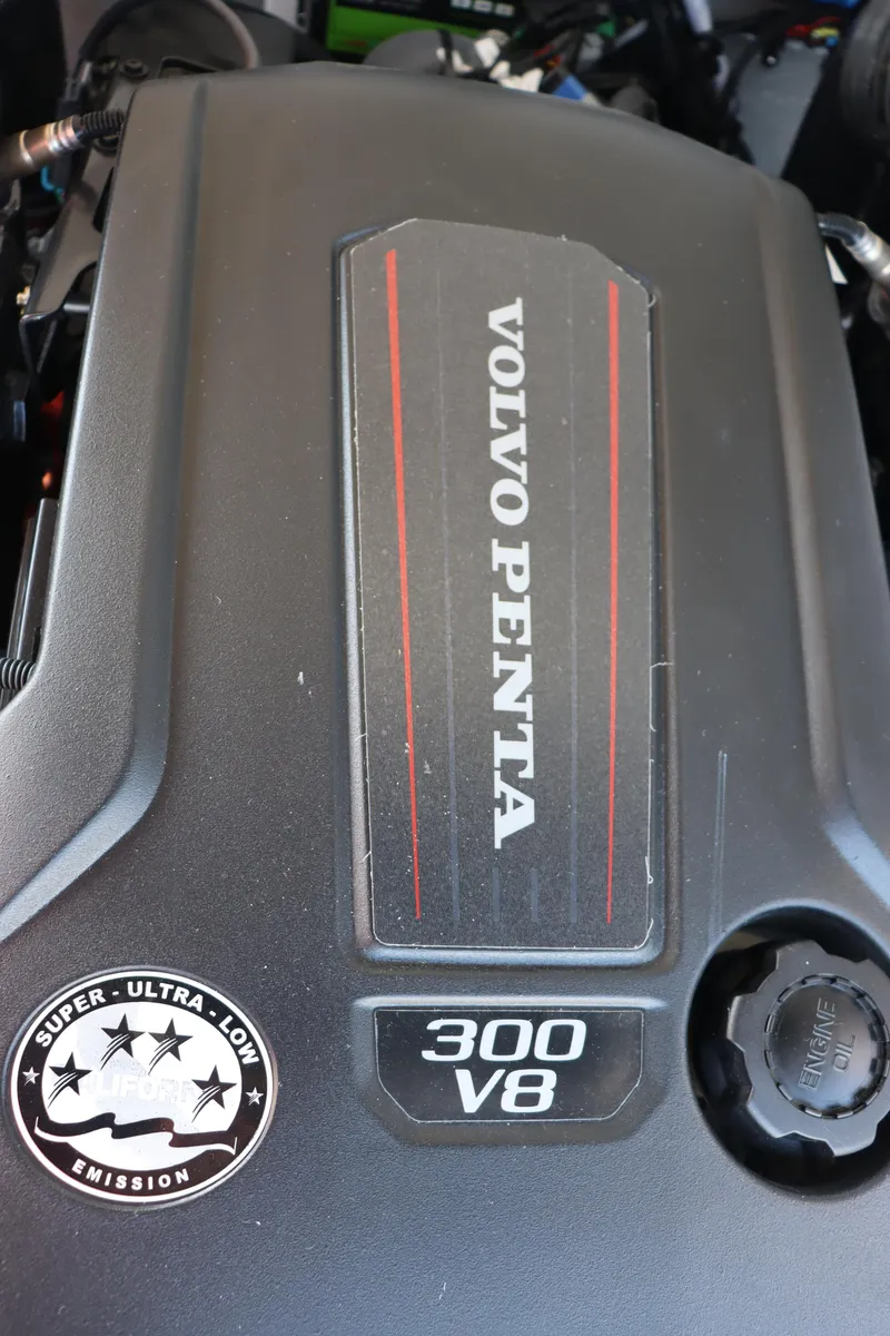 Slide: The Image of 2024 Crownline Eclipse E255 SURF interior storage compartment with blue LED lighting. - 4