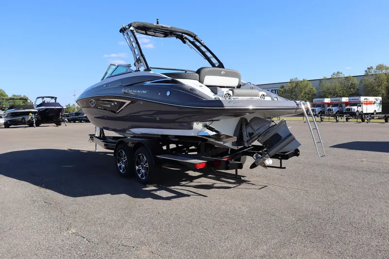 Slide: The Image of 2024 Crownline Eclipse E255 SURF boat interior with blue LED lights in showroom. - 7