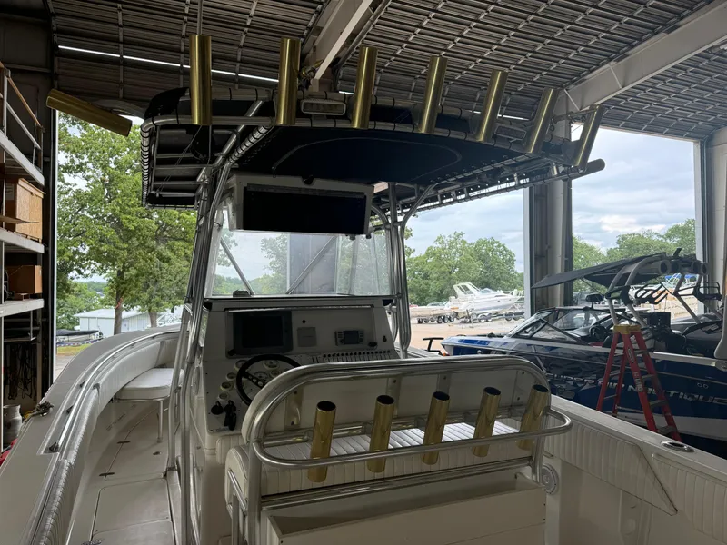 Slide: The Image of 2007 Fountain 32 CC boat in storage, featuring a central console and rod holders. - 12