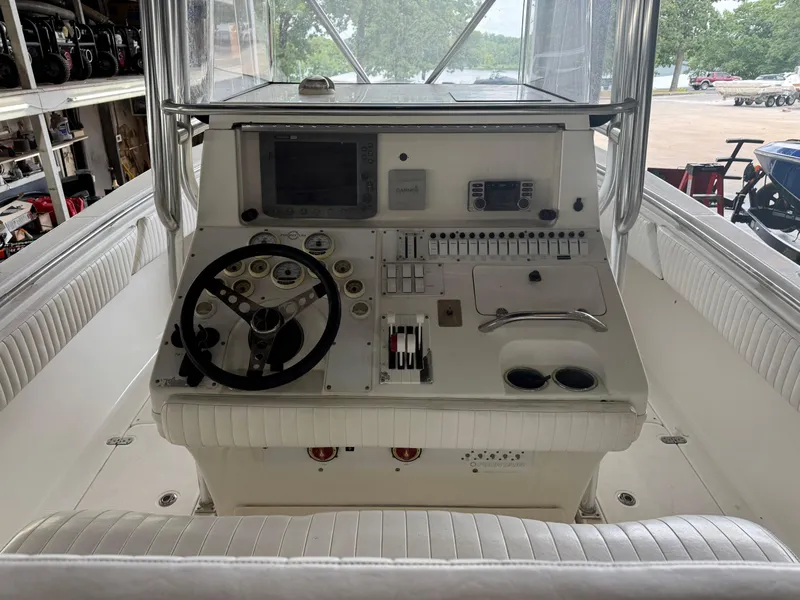 Slide: The Image of 2007 Fountain 32 CC boat dashboard with steering wheel and control panel. - 13