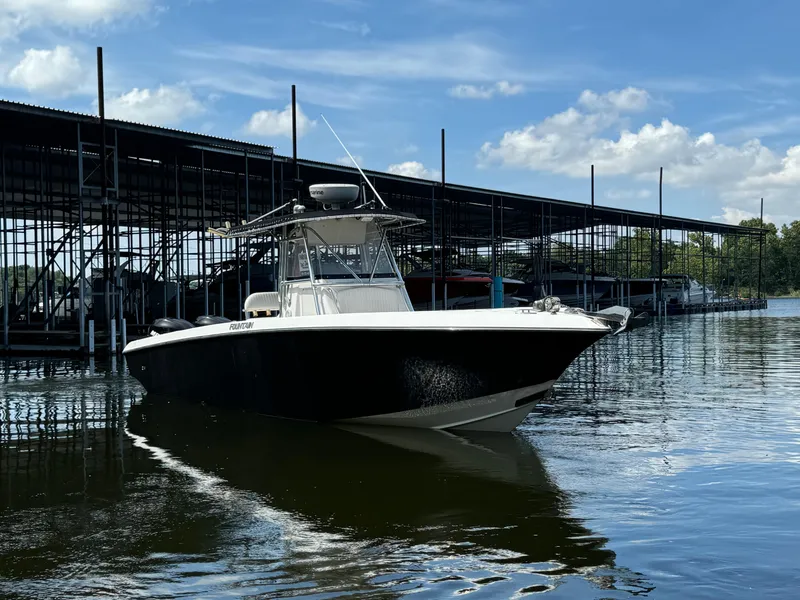 Slide: The Image of 2007 Fountain 32 CC boat docked at marina under blue sky. - 2