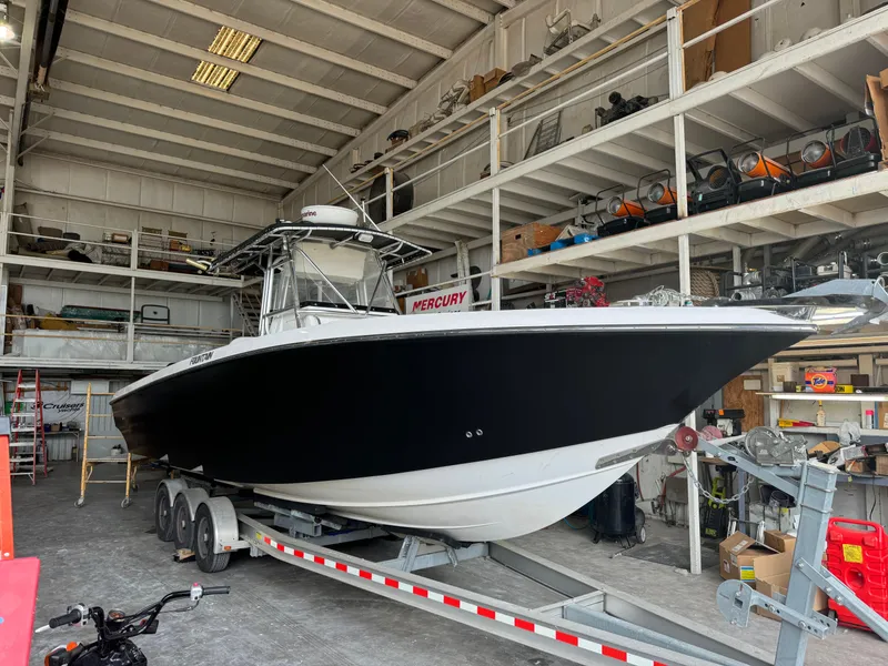 Slide: The Image of 2007 Fountain 32 CC boat on trailer in a storage facility. - 5