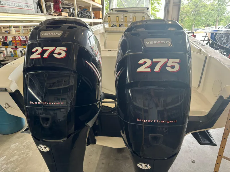 Slide: The Image of Twin Verado 275 Supercharged engines on a 2007 Fountain 32 CC boat in a garage. - 7