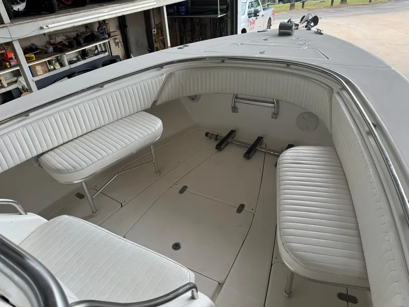 Slide: The Image of 2007 Fountain 32 CC boat interior with white seating and spacious deck area. - 9