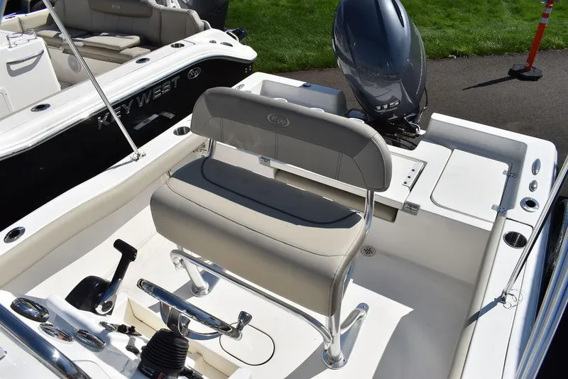 Slide: The Image of 2024 Key West 179 FS boat interior with seating and motor, showcasing modern design. - 11