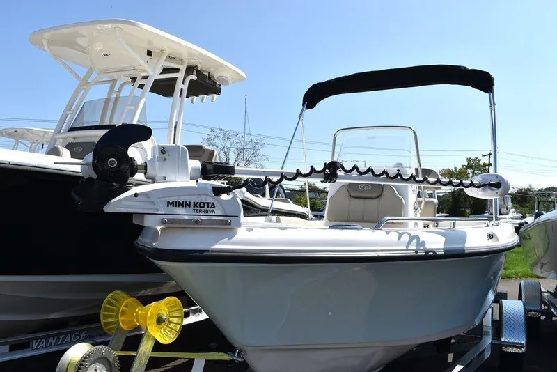 Slide: The Image of 2024 Key West 179 FS boat with Minn Kota trolling motor, displayed outdoors. - 2