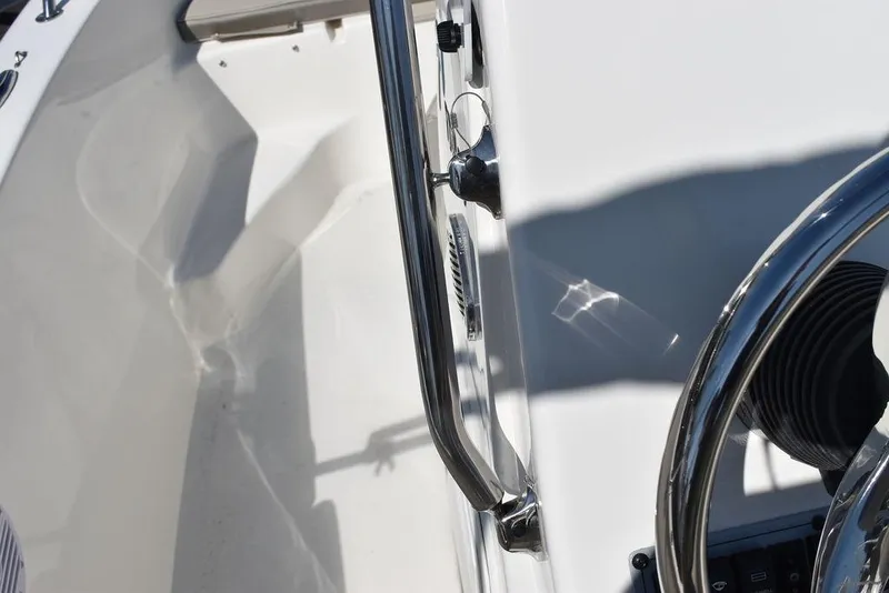 Slide: The Image of 2024 Key West 179 FS boat interior with steering wheel and stainless steel rail. - 23