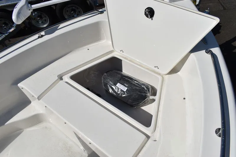 Slide: The Image of 2024 Key West 179 FS boat storage compartment with open lid. - 28
