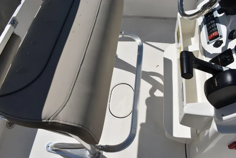 Slide: The Image of 2024 Key West 179 FS boat interior with steering console and cushioned seat. - 32