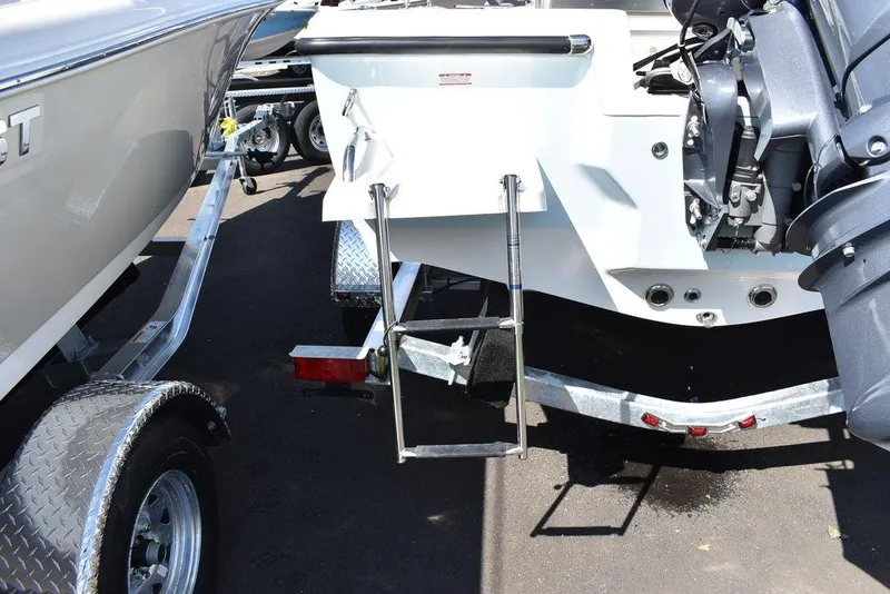 Slide: The Image of 2024 Key West 179 FS boat with trailer and motor, featuring a rear ladder. - 33