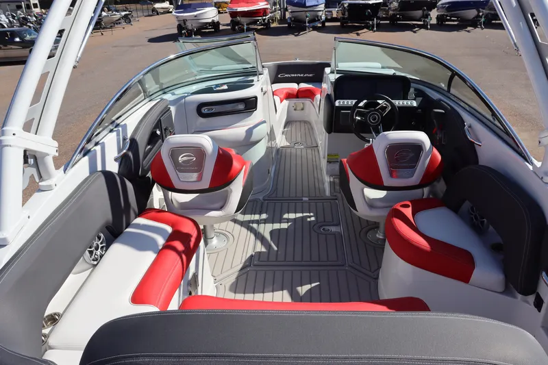 Slide: The Image of 2024 Crownline 260SS SURF boat interior with red and white seating, steering wheel, and dashboard. - 12