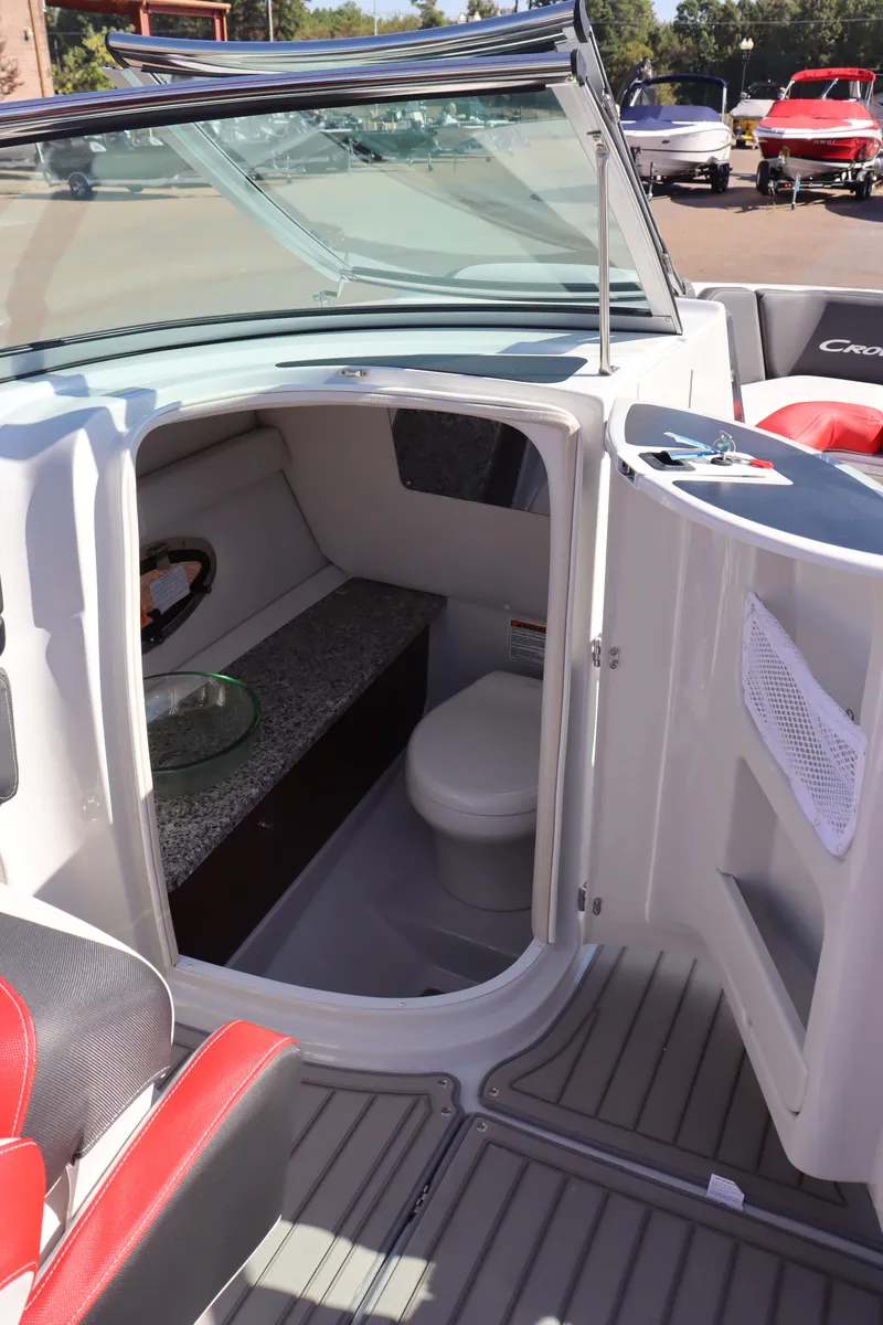 Slide: The Image of 2024 Crownline 260SS SURF boat interior with cabin and seating area. - 16