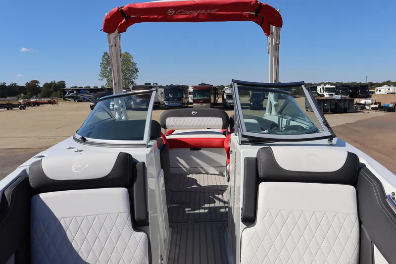 Slide: The Image of 2024 Crownline 260SS SURF boat interior with red canopy and white seating. - 17