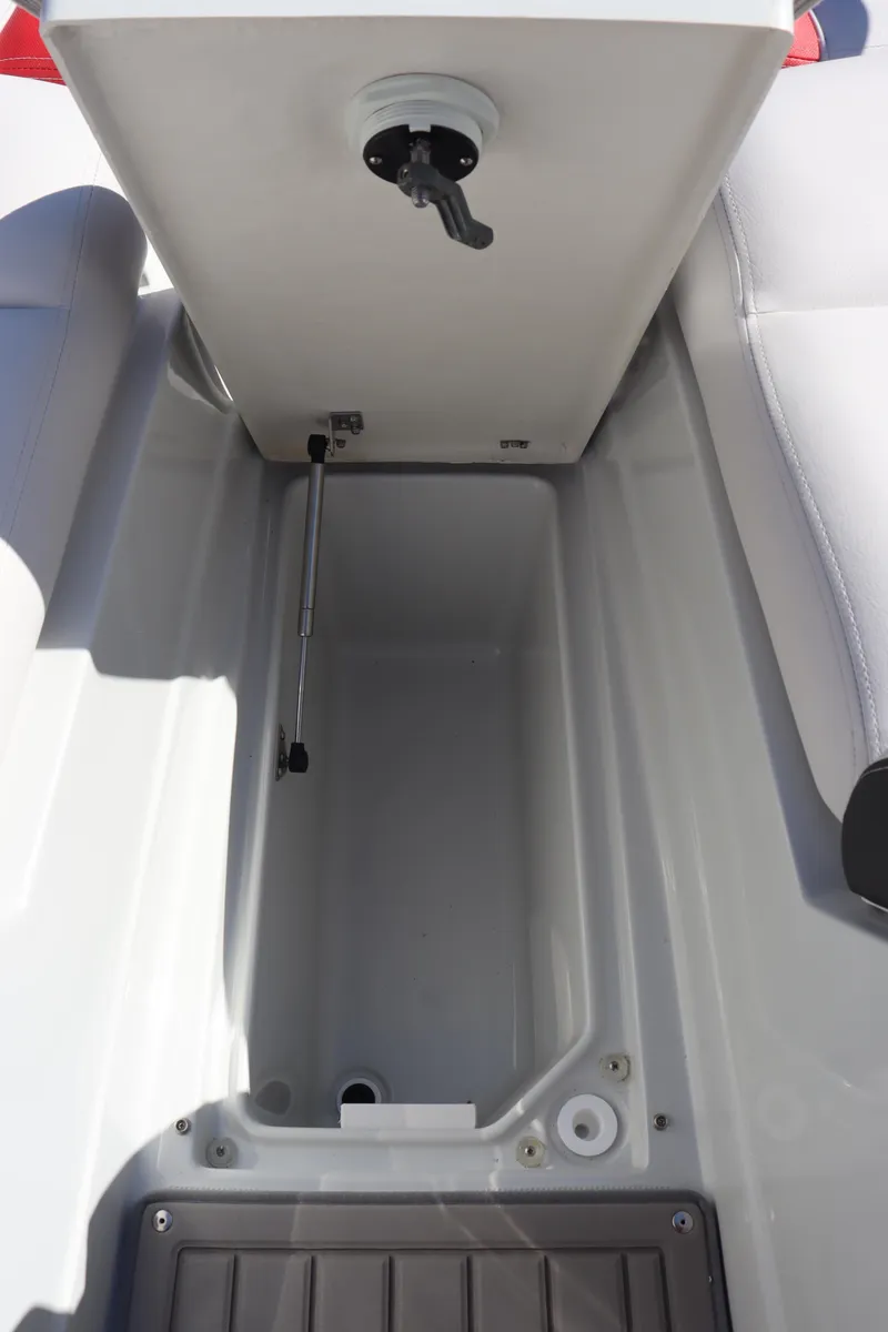 Slide: The Image of Open storage compartment on a 2024 Crownline 260SS SURF boat. - 19
