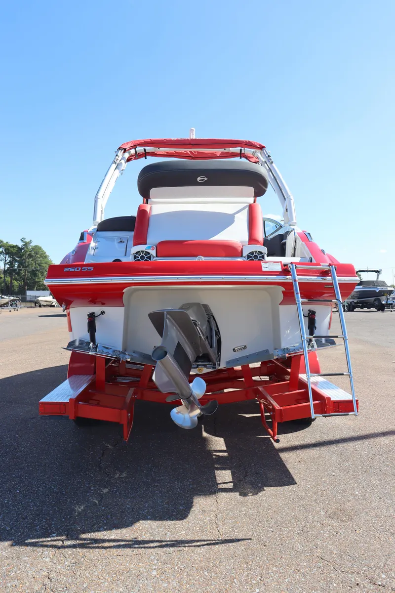 Slide: The Image of 2024 Crownline 260SS SURF boat, rear view with ladder and propeller. - 28