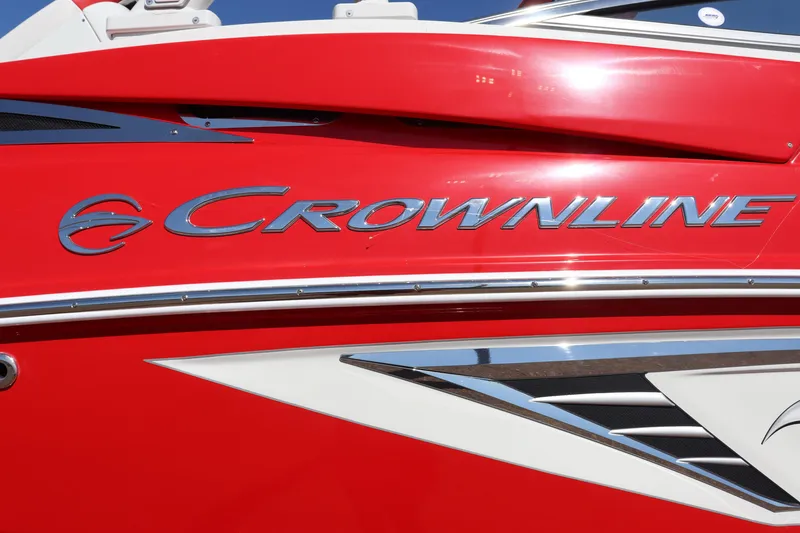 Slide: The Image of 2024 Crownline 260SS SURF boat, red exterior with sleek design. - 5
