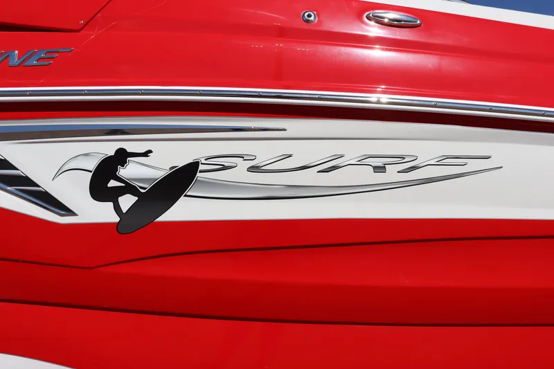 Slide: The Image of 2024 Crownline 260SS SURF boat with red and white exterior and surfboard graphic. - 6