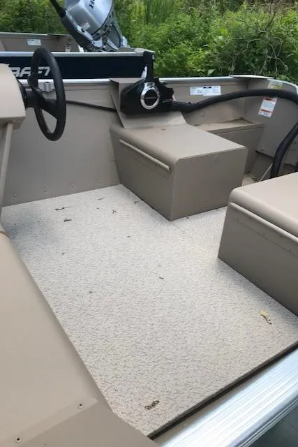 Slide: The Image of 2024 Polar Kraft Dakota 1670 boat interior with seating and steering wheel. - 4