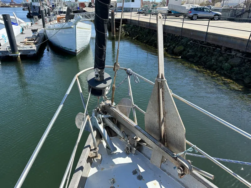 Slide: The Image of Bow view of a 2000 Bruce Roberts Ketch docked in a marina. - 13