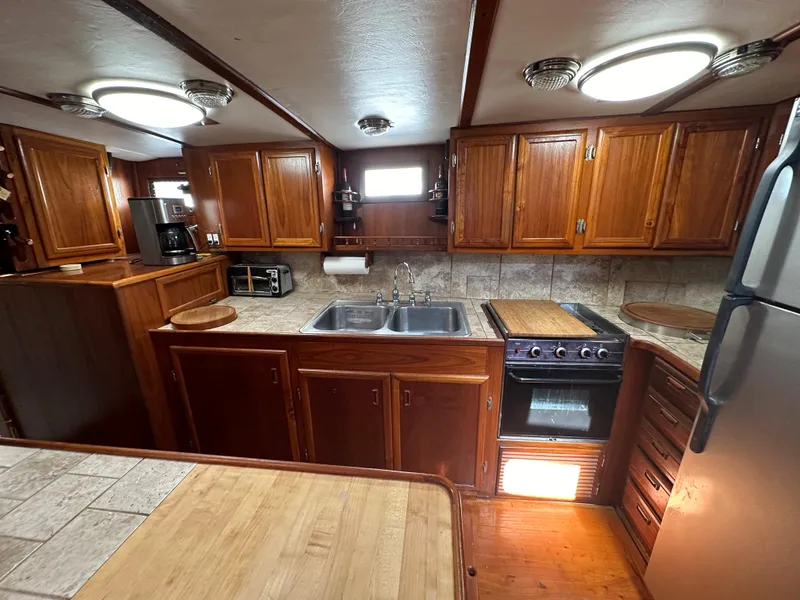 Slide: The Image of Spacious kitchen in 2000 Bruce Roberts Ketch with wooden cabinets and modern appliances. - 23