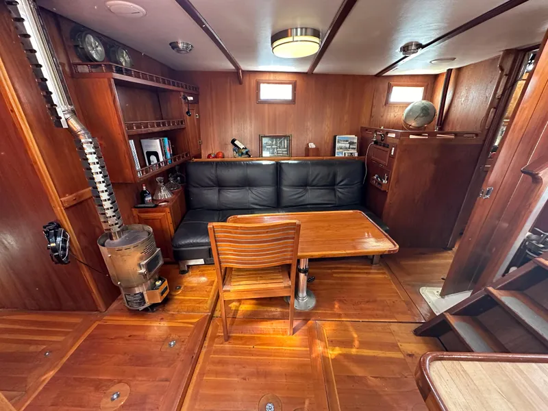 Slide: The Image of Cozy interior of 2000 Bruce Roberts Ketch with wood paneling and seating area. - 29
