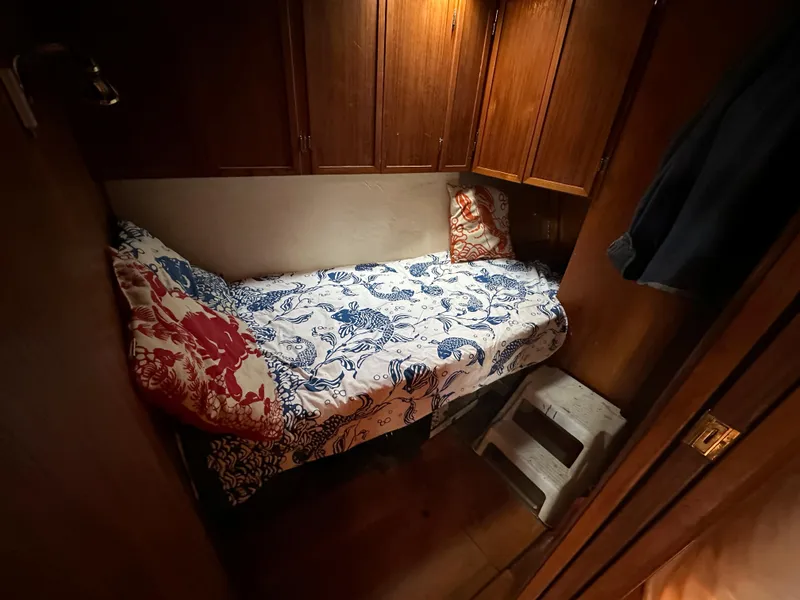 Slide: The Image of Cozy cabin interior of 2000 Bruce Roberts Ketch with nautical-themed bedding. - 34