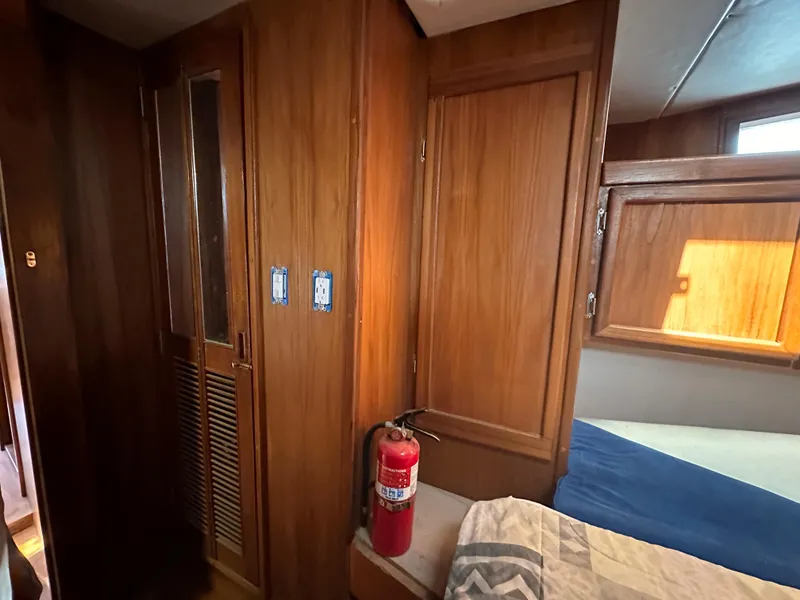 Slide: The Image of Interior of 2000 Bruce Roberts Ketch with wood paneling and fire extinguisher. - 39