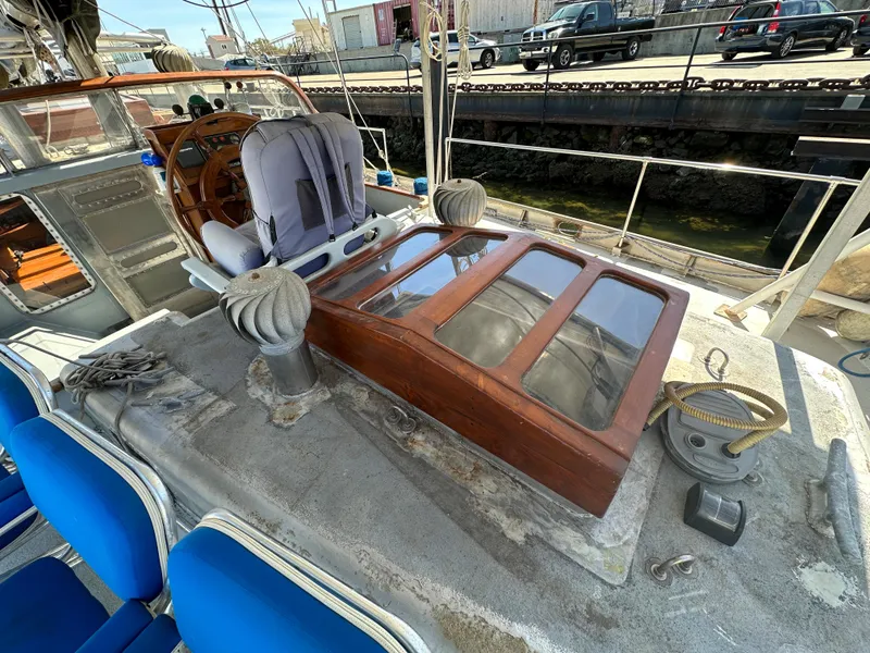 Slide: The Image of Bruce Roberts Ketch 2000 sailboat deck with wooden hatch and nautical equipment. - 4
