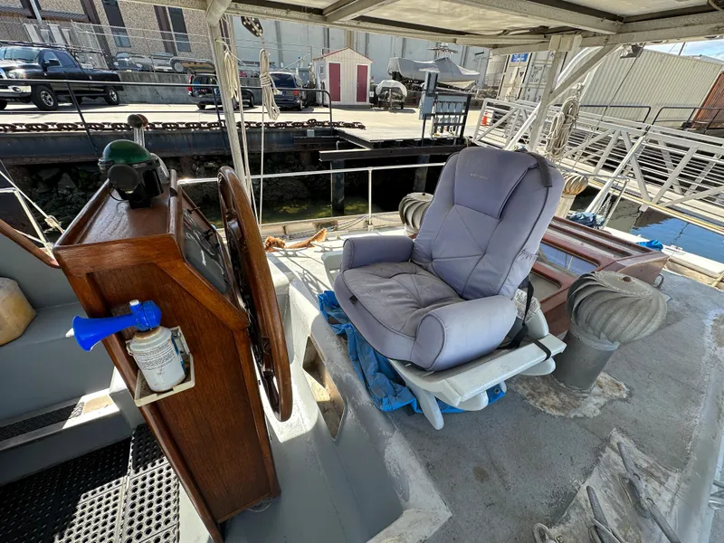 Slide: The Image of Captain's chair on 2000 Bruce Roberts Ketch sailboat deck, docked at marina. - 5