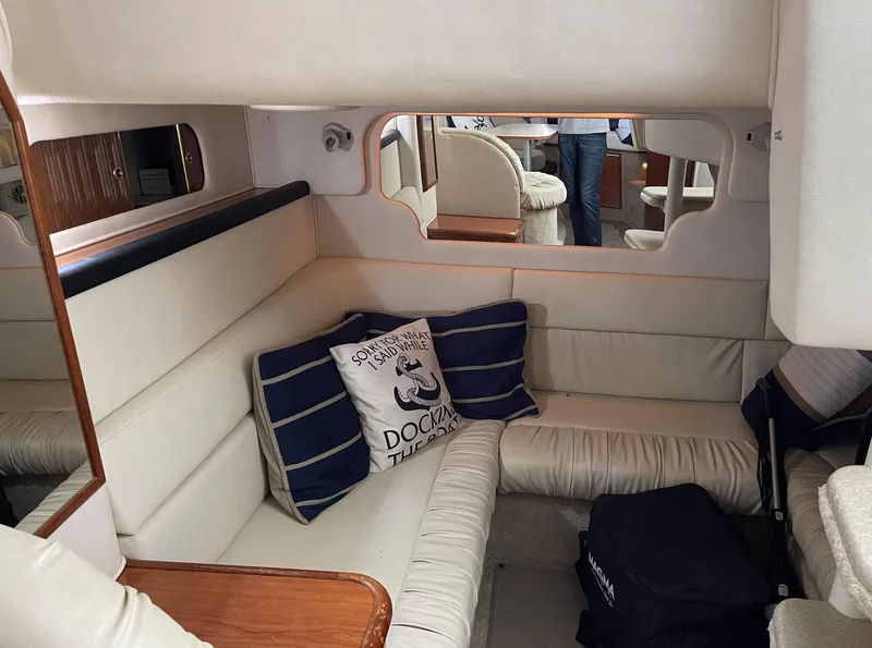 Slide: The Image of Interior of 2001 Sea Ray 340 Sundancer with cozy seating and nautical decor. - 10