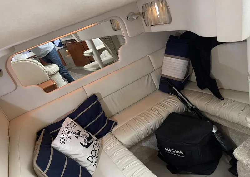 Slide: The Image of Interior of 2001 Sea Ray 340 Sundancer with white seating and nautical-themed pillows. - 11