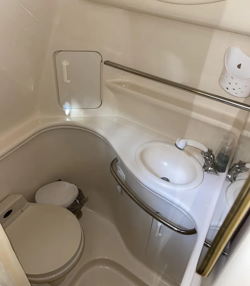 Slide: The Image of 2001 Sea Ray 340 Sundancer bathroom with sink, toilet, and storage. - 15