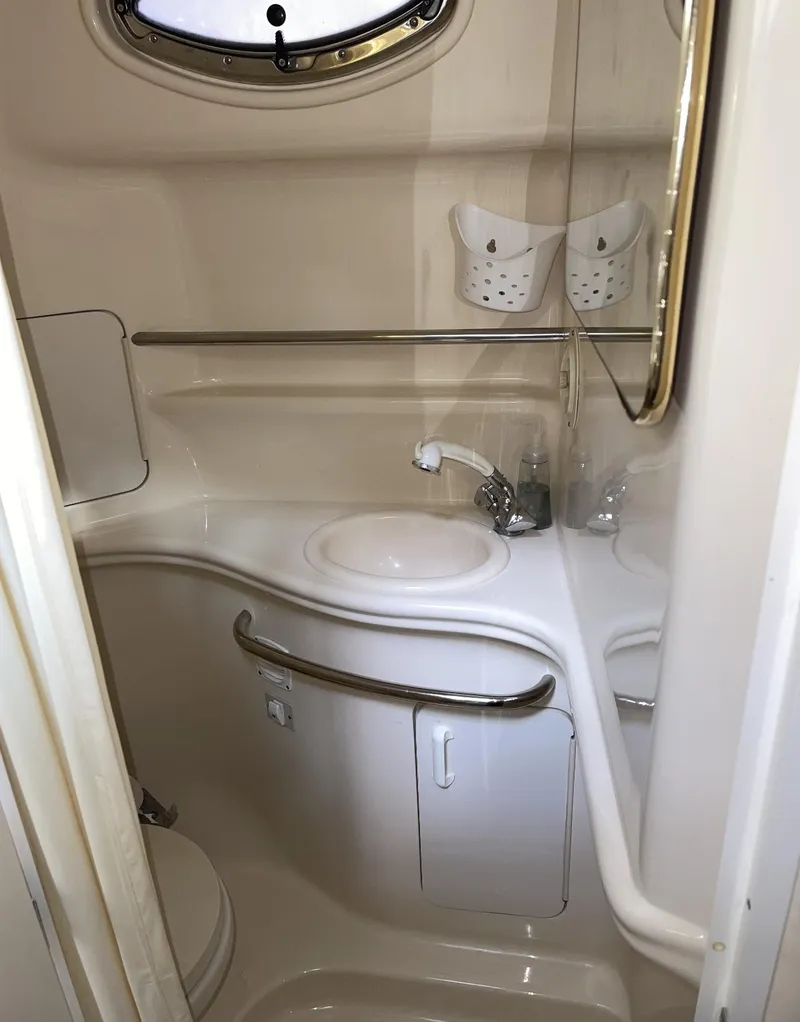 Slide: The Image of 2001 Sea Ray 340 Sundancer bathroom with sink, faucet, and storage. - 16