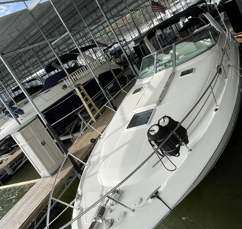 Slide: The Image of 2001 Sea Ray 340 Sundancer docked in a covered marina. - 2